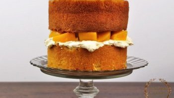 Overfilled peach and white chocolate cake by Juniper Cakery
