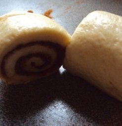 slicing dough for cinnamon rolls