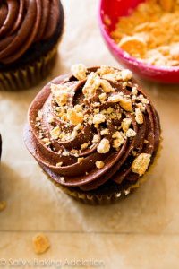 S'mores have never tasted so good! Moist and rich homemade chocolate cupcakes filled with marshmallow, topped with chocolate frosting, graham cracker crumbs, and a toasted marshmallow.